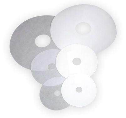 a group of white disc filters with holes in them on a white background .