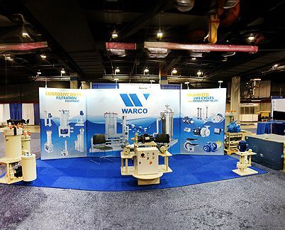 a warco booth at a convention with a lot of equipment on display .