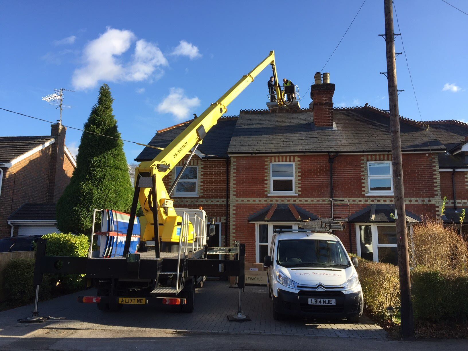 Cherry picker accessing roof on residential house
