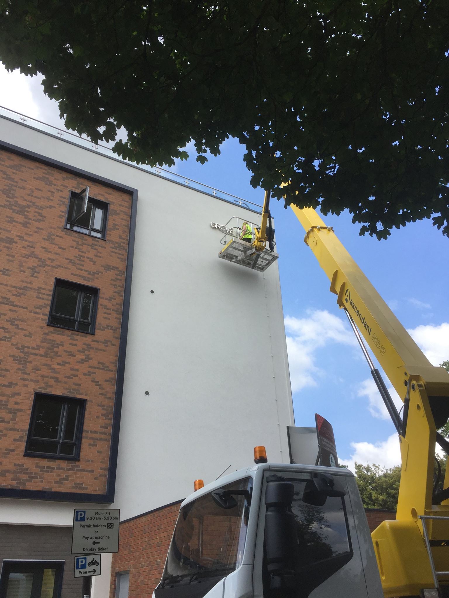 Cherry picker accessing third floor on residential flats
