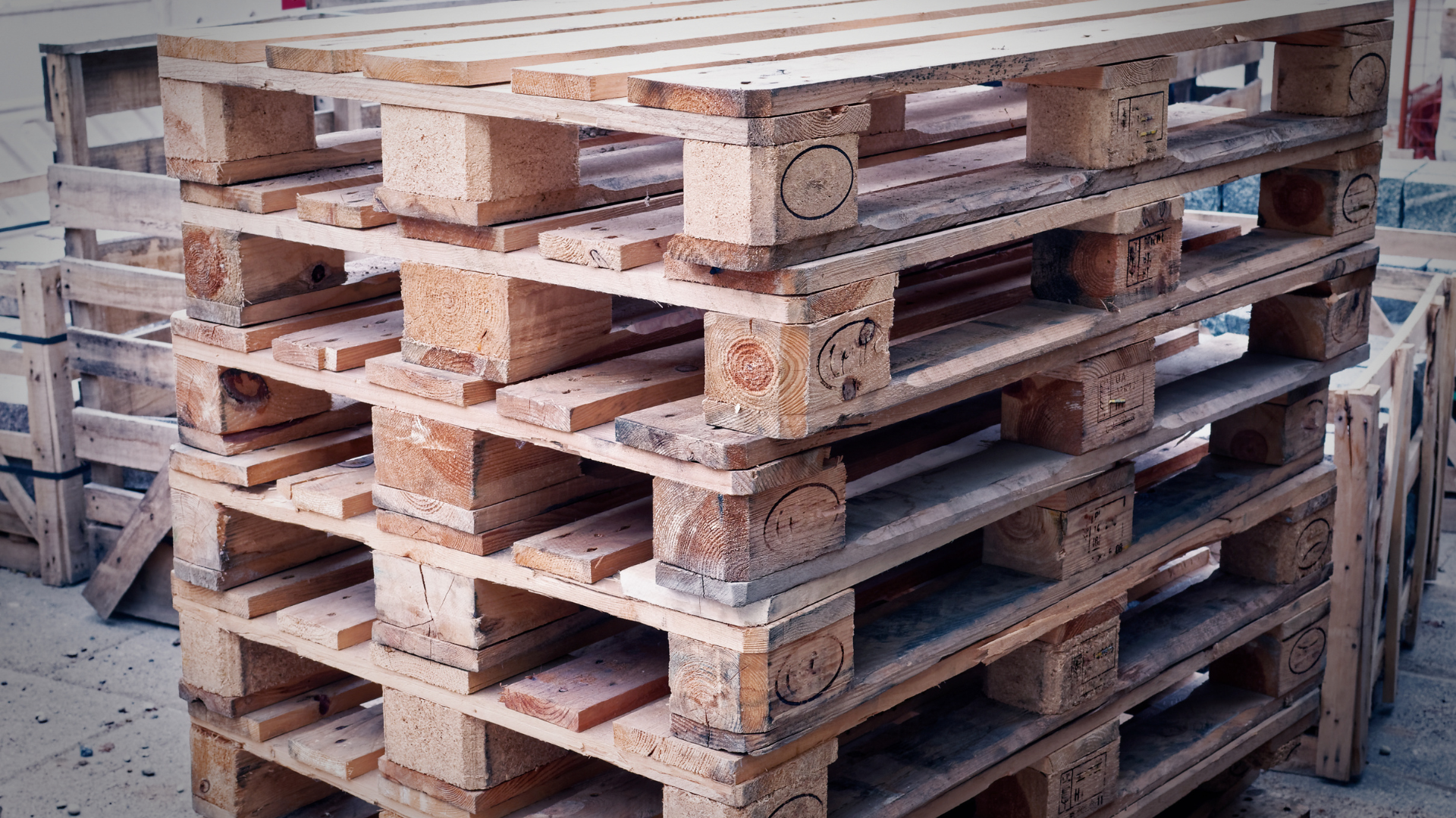 A pile of colorful wooden pallets stacked on top of each other.