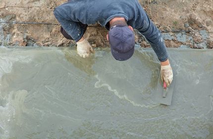 concrete contractor spreading the cement