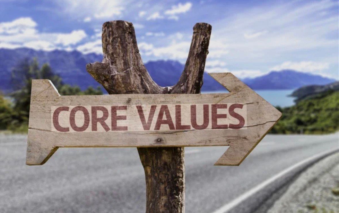 A man is sitting on a couch talking to another man.