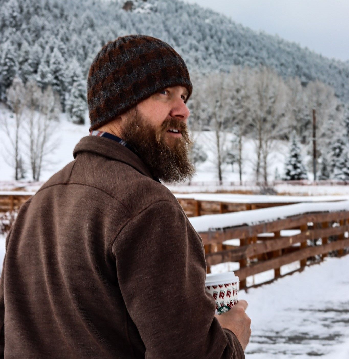 A man is sitting on a couch talking to another man.