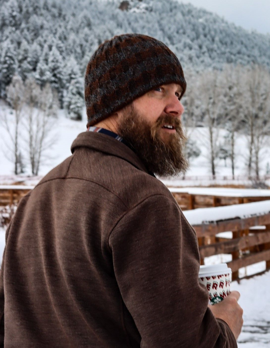 A man and a woman are sitting on a couch talking to each other.