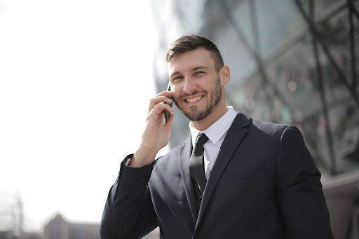 Man in a suit holding a cell phone