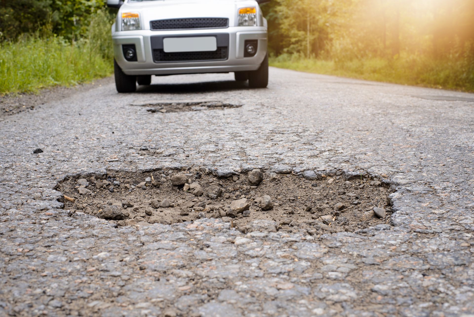 Can Hitting a Pothole or Curb Lead To Suspension Repair And Alignment Problems? | Woodie's Auto Serv