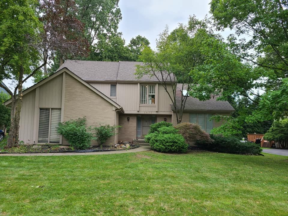 A large house with a lush green lawn in front of it