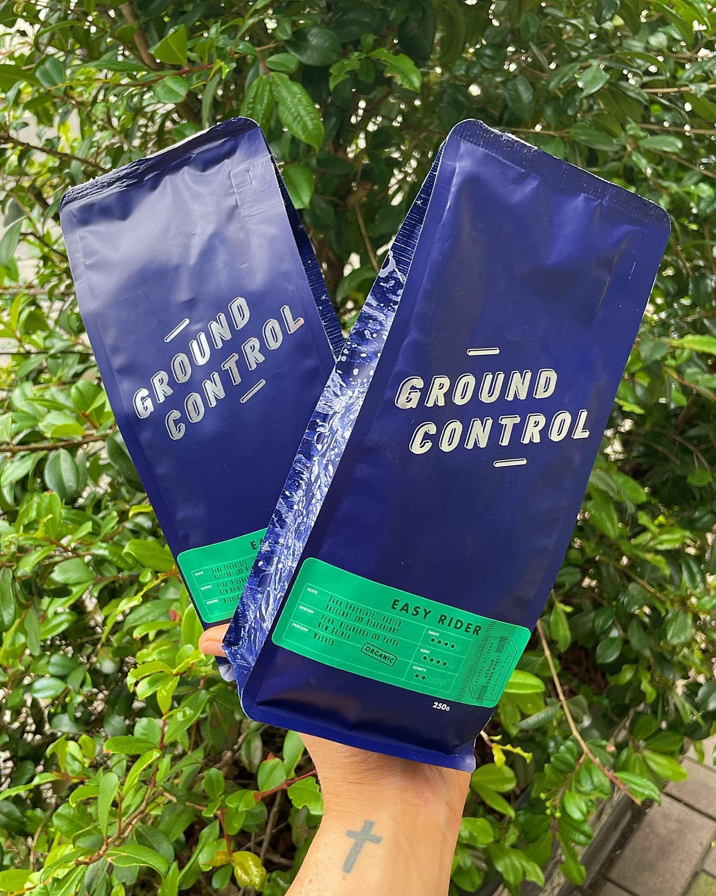 Barista Pours Milk Into a Latte, Creating a Design in a Glass Cup — Drop In Espresso Bar in Wallsend, NSW
