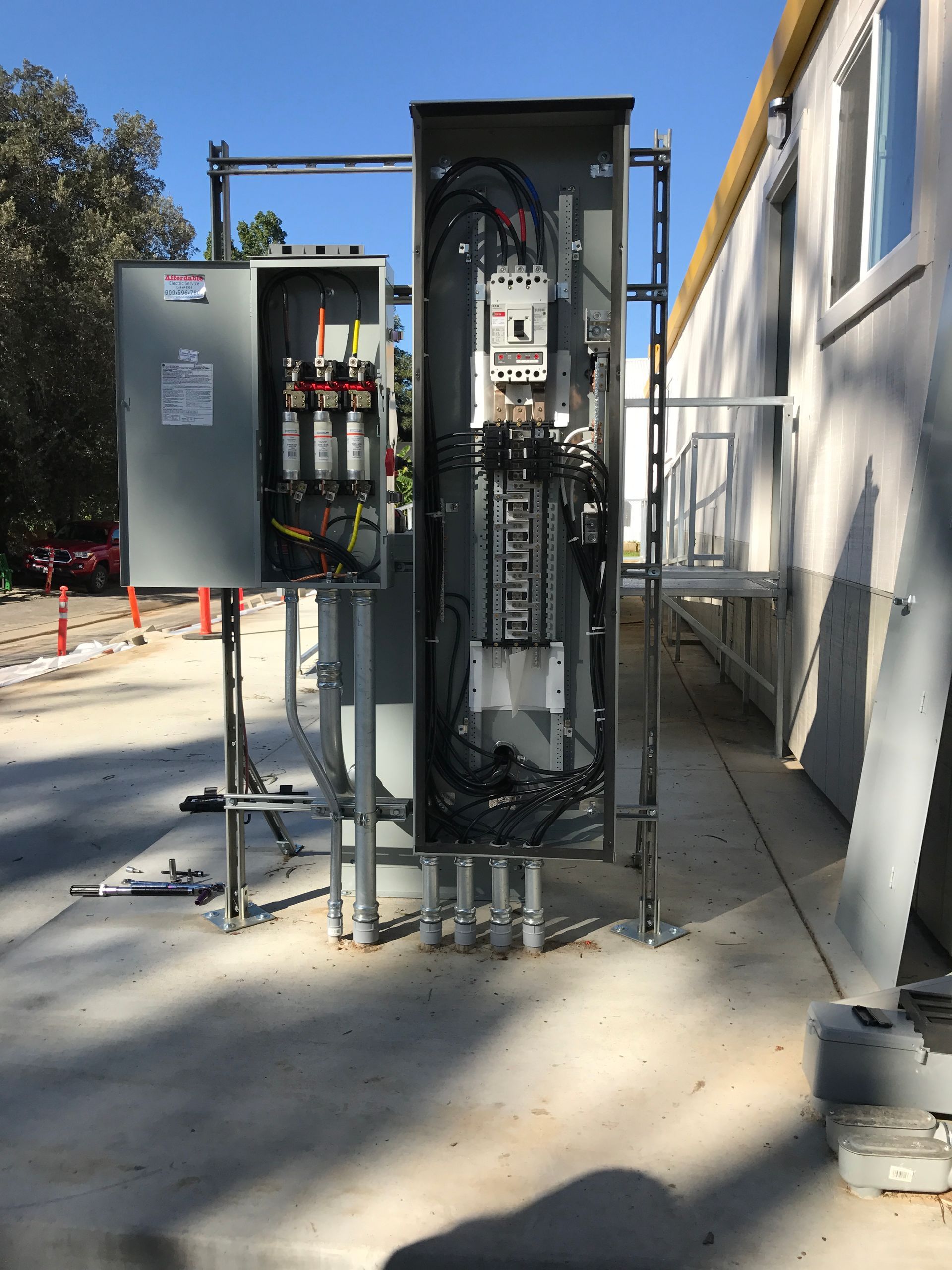 Electrical panel and conduit outside a building.