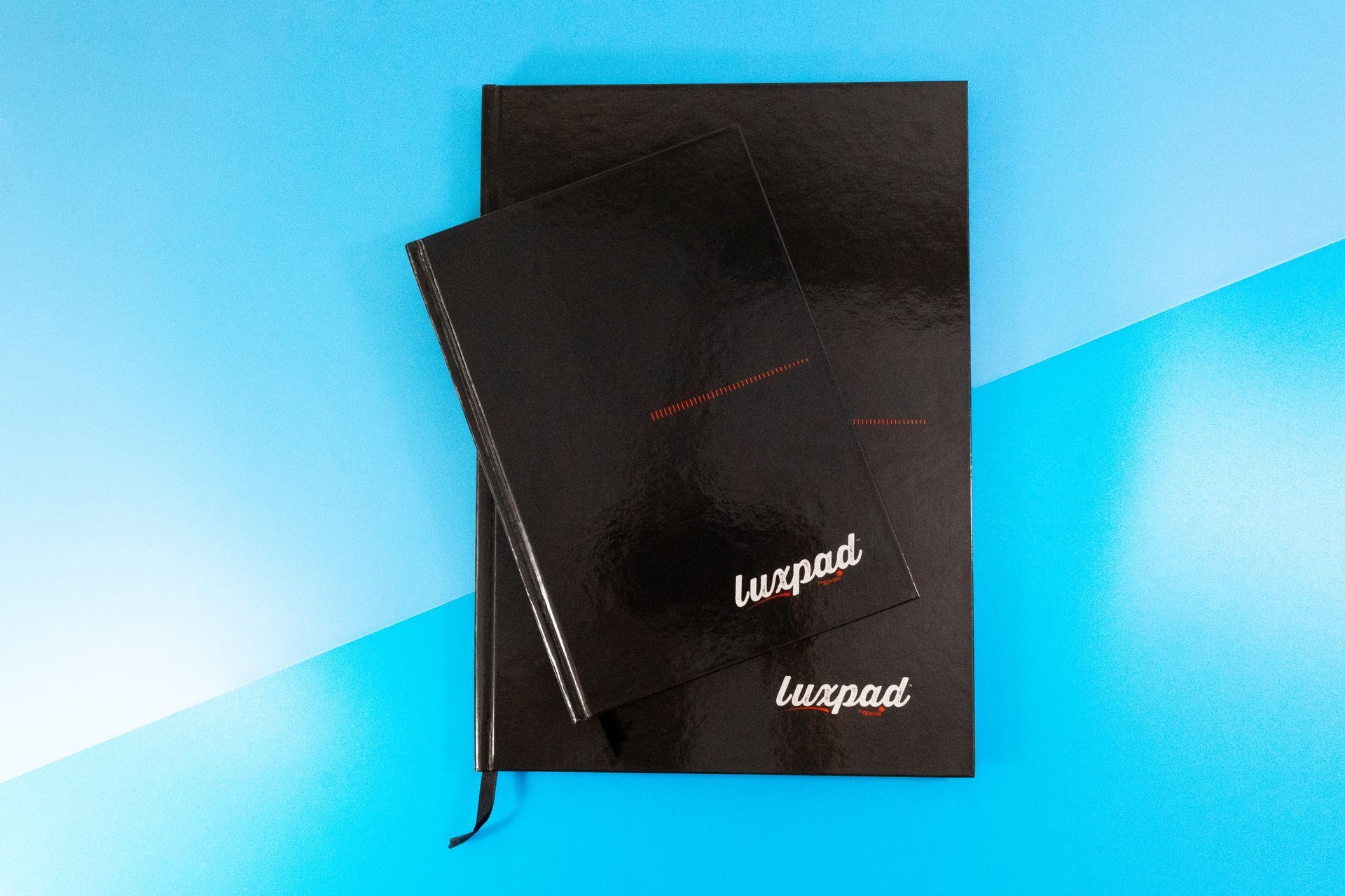 A5 and A4 black casebound books by Silvine on a blue background