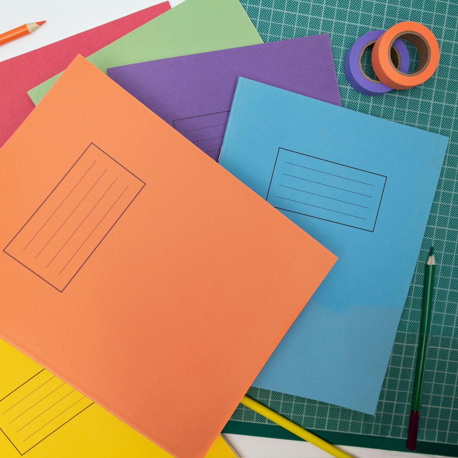 Exercise Books with pencils, washi tape and cutting mat.