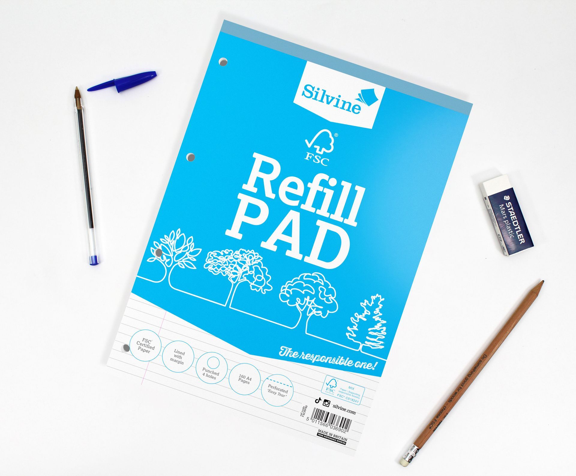 FSC® Certified Refill Pad on white desk with pen, pencil and rubber scattered around it.