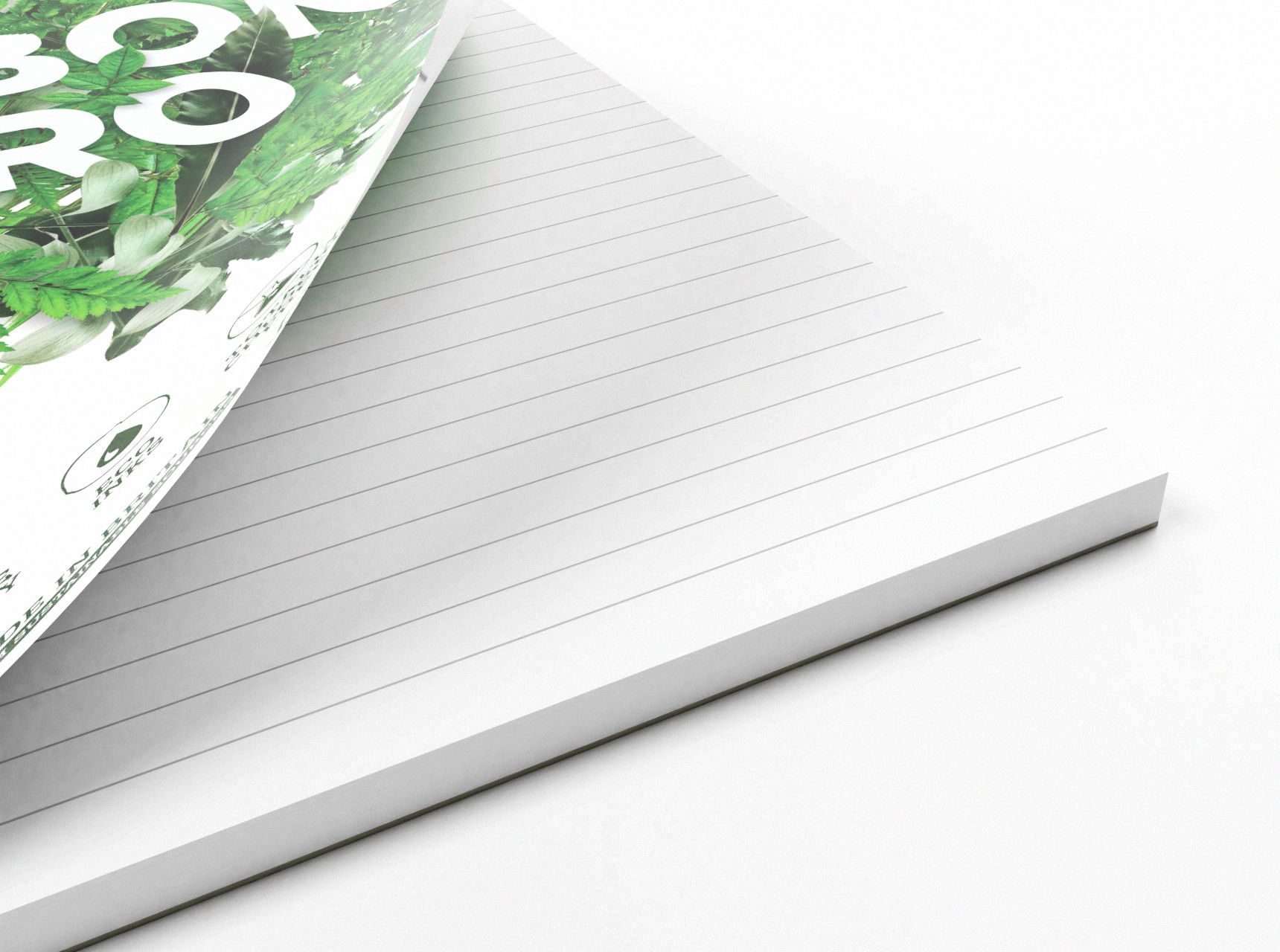 Corner of a 100% recycled refill pad on white background. The pad is open to reveal the lined paper inside.