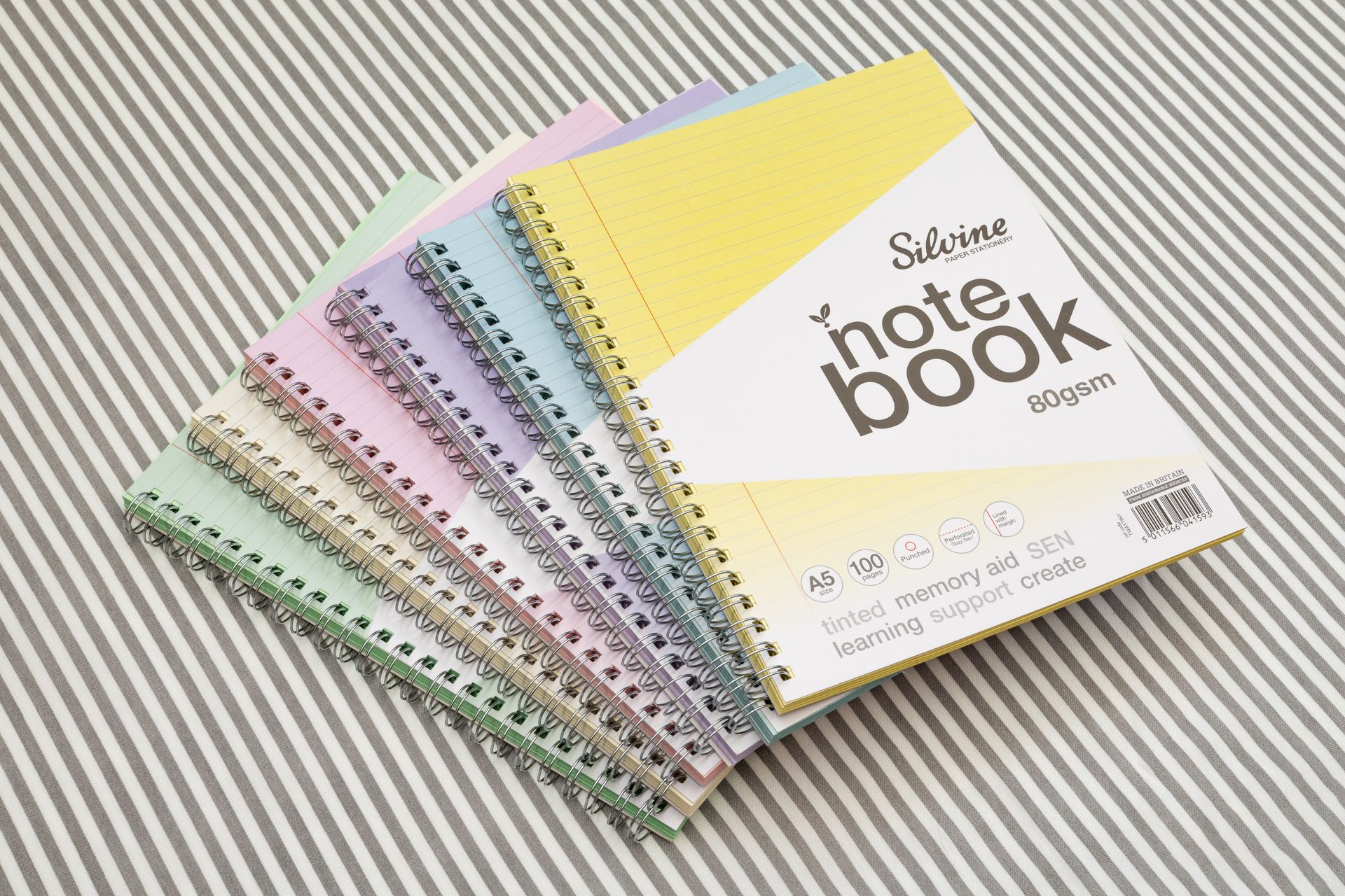 Silvine Tinted notebooks on striped background