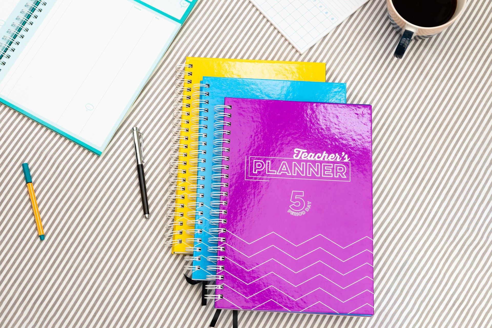 Silvine teachers planners on stiped background with desk accessories