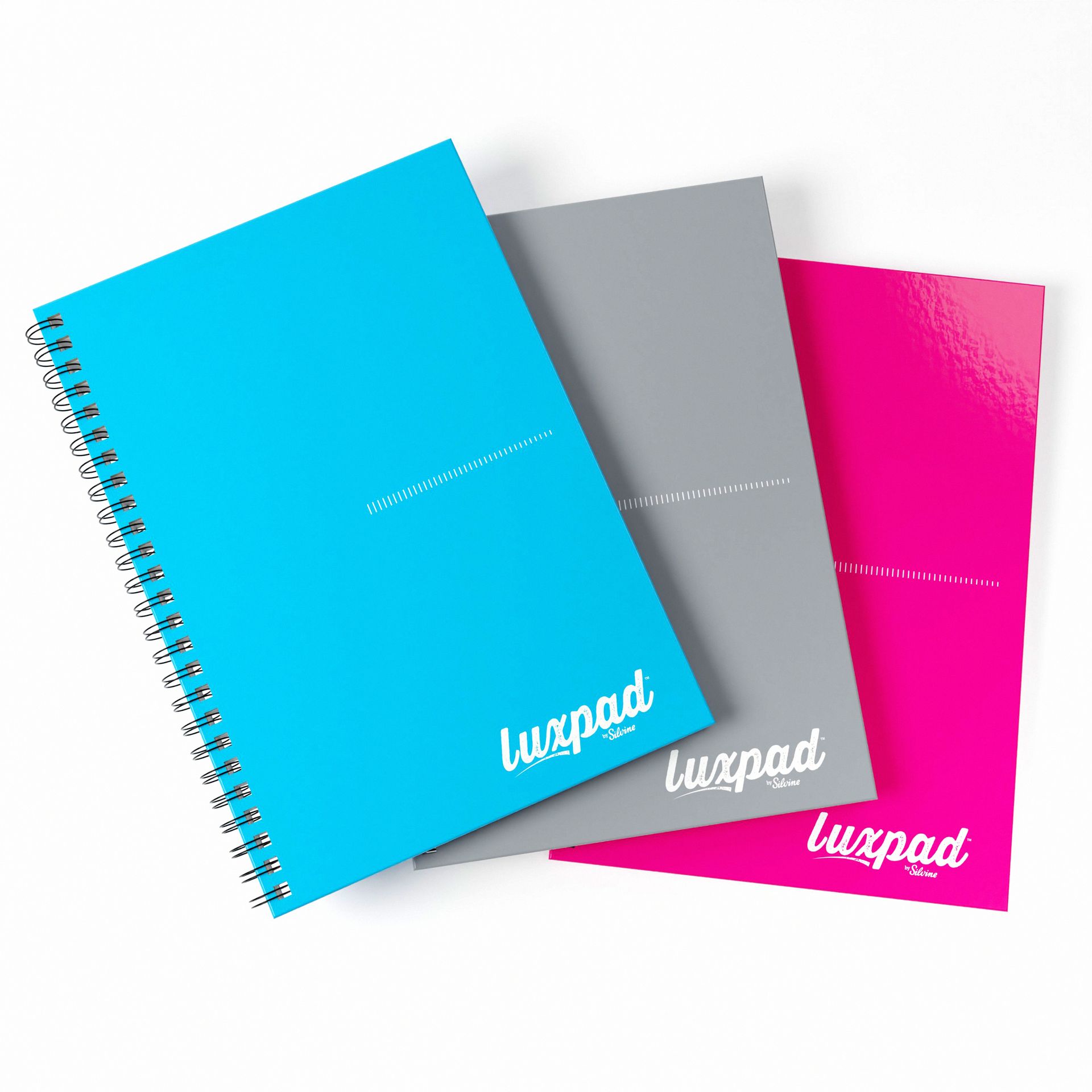 Blue, grey and pink hardback notebooks on a white background