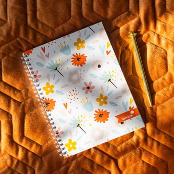 Floral Marlene West Notebook on quilted background and gold pen.