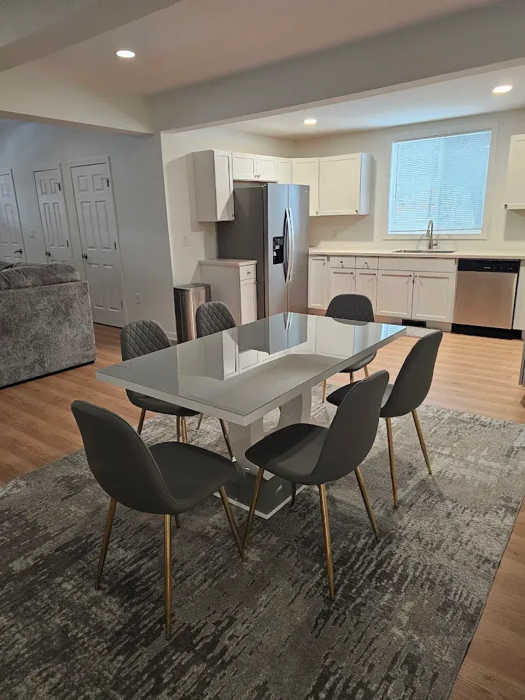 Glass windows reflect greenery from outside, with metal frame.