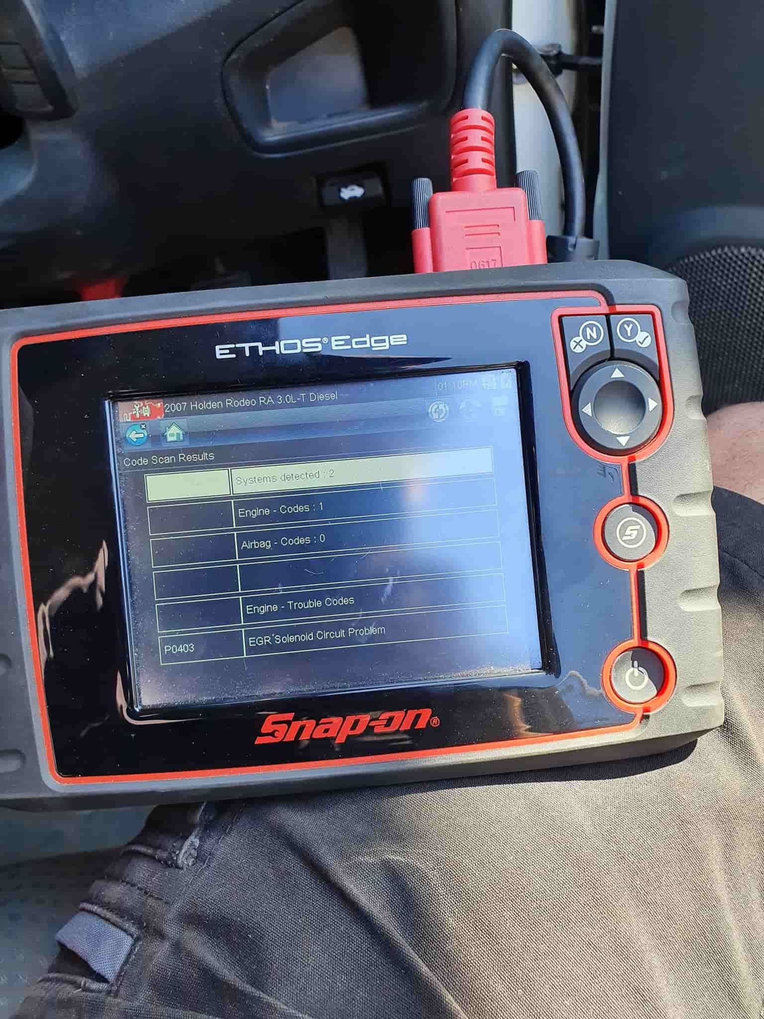 A Snap on Device is Sitting on a Person's Lap — OSP Automotive & Marine In Grafton, NSW