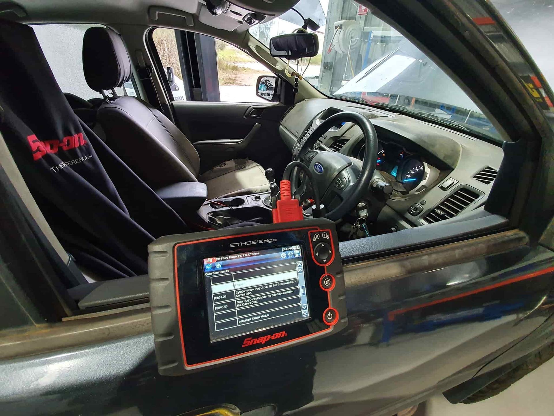 The Inside of a Car With a Diagnostic Tool on the Dashboard — OSP Automotive & Marine In Grafton, NSW