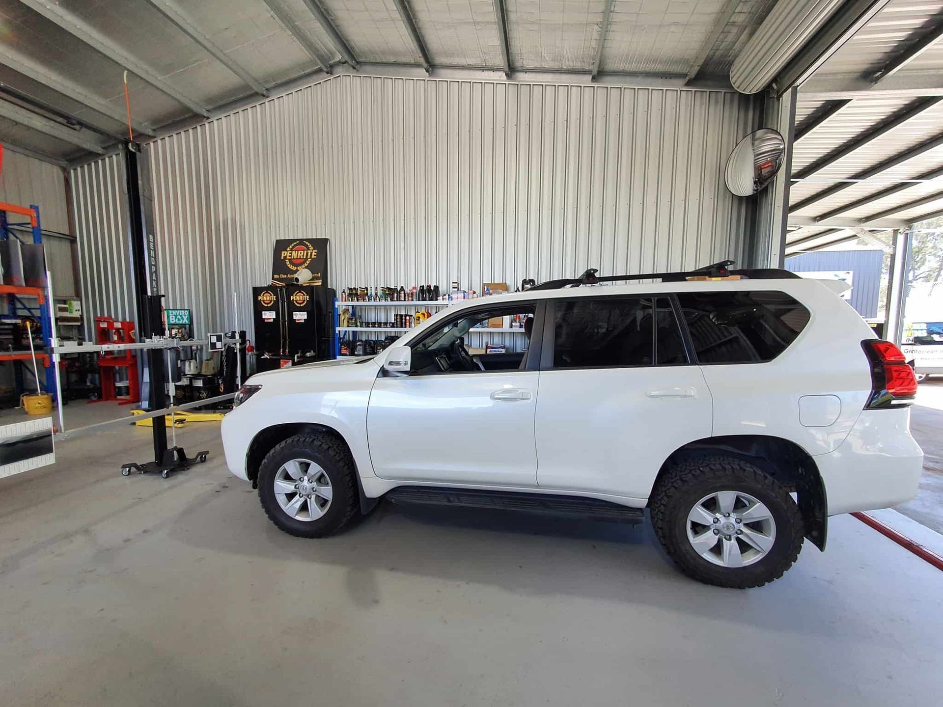 A White Suv is Parked Inside of a Garage — OSP Automotive & Marine In Grafton, NSW
