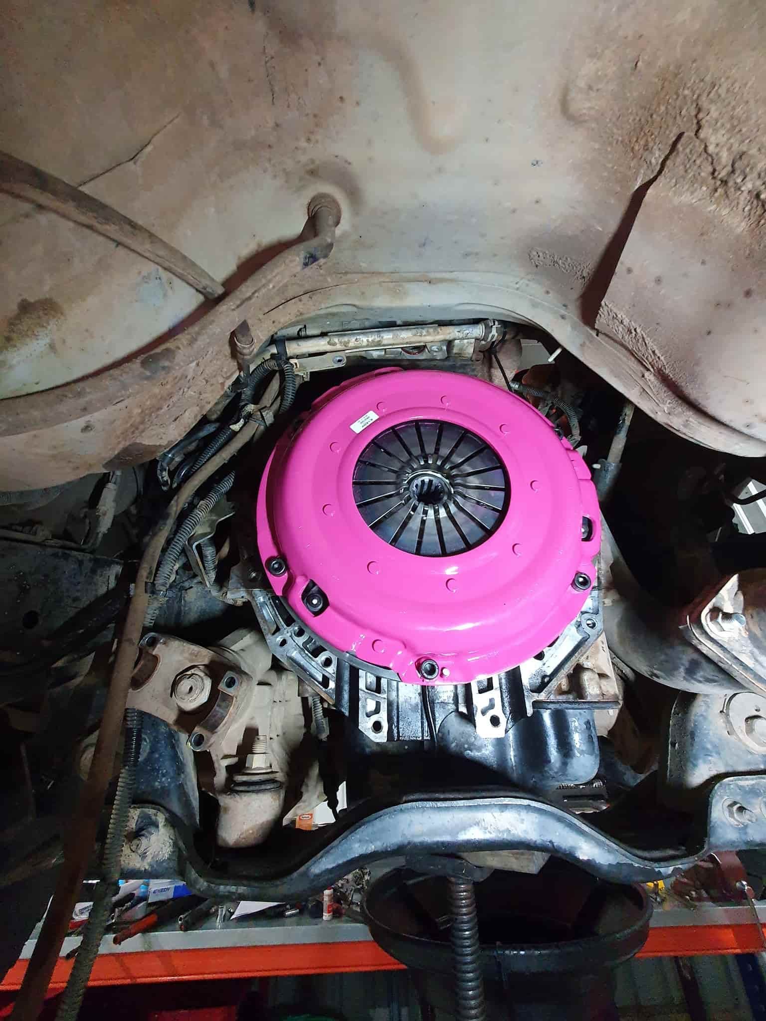 A Pink Clutch Cover is Sitting on Top of a Car Engine — OSP Automotive & Marine In Grafton, NSW