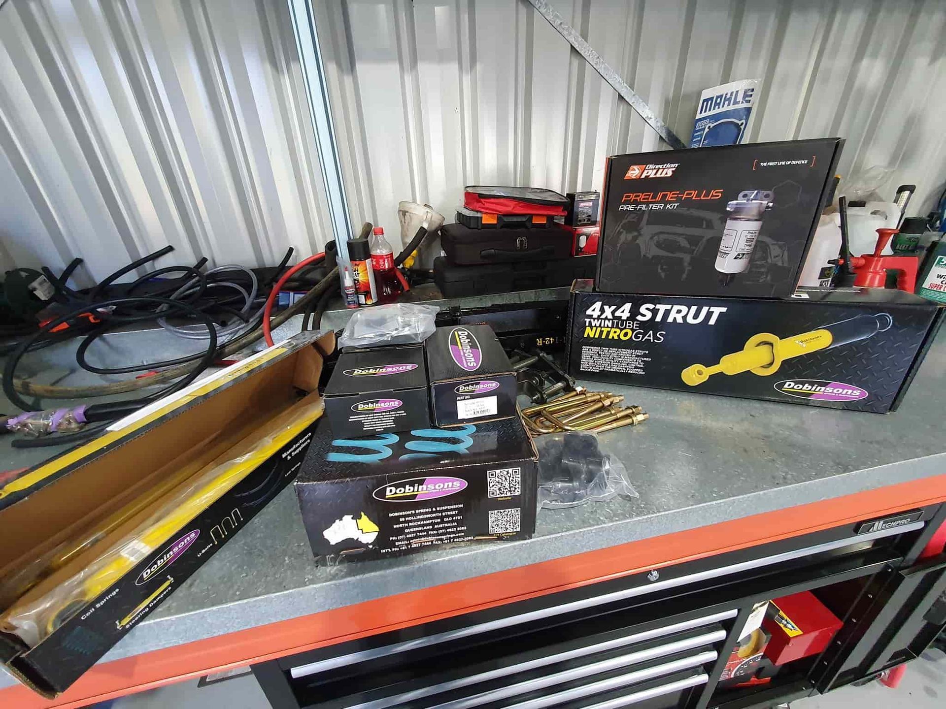 A Bunch of Boxes Are Sitting on a Shelf in a Garage — OSP Automotive & Marine In Grafton, NSW