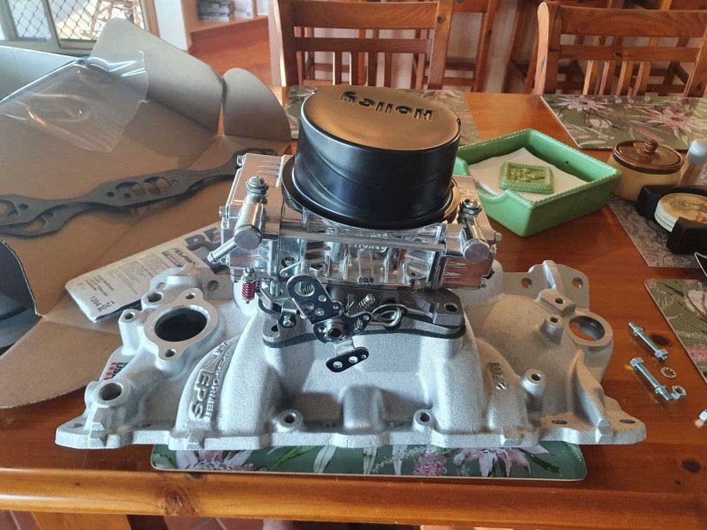 A Carburetor is Sitting on Top of a Wooden Table — OSP Automotive & Marine In Grafton, NSW