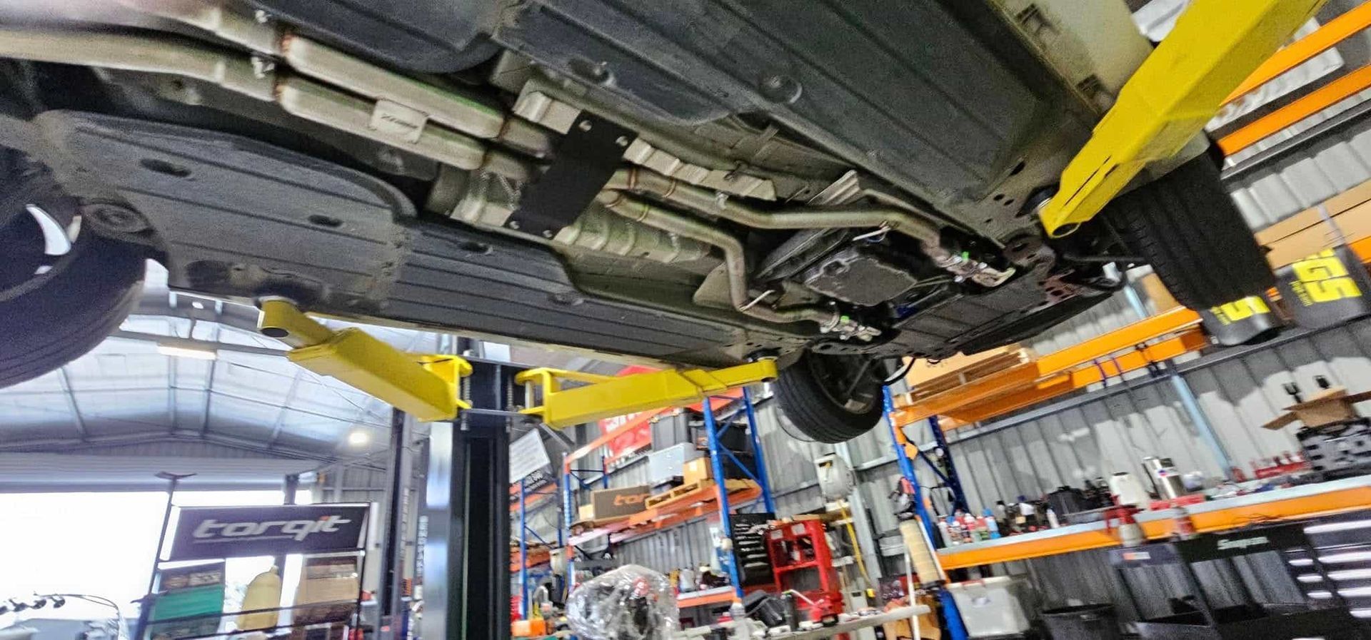 A Car is Sitting on a Lift in a Garage — OSP Automotive & Marine In Grafton, NSW