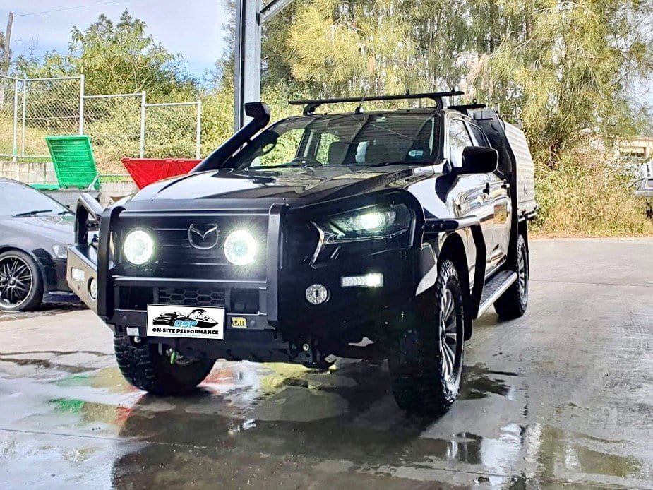 A Black Truck With a Roof Rack is Parked in a Parking Lot — OSP Automotive & Marine In Grafton, NSW
