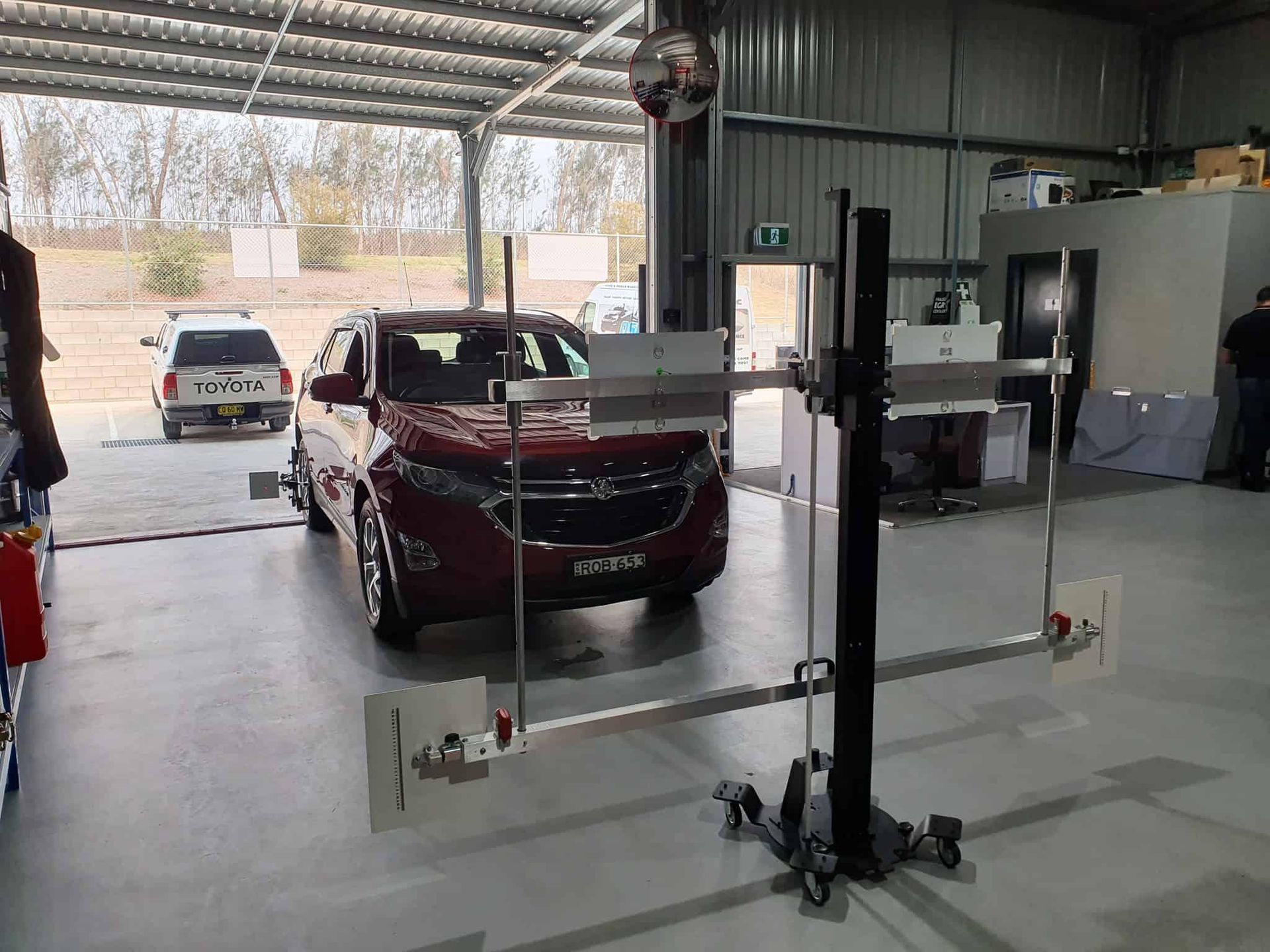 A Red Car is Parked in a Garage Next to a Machine — OSP Automotive & Marine In Grafton, NSW