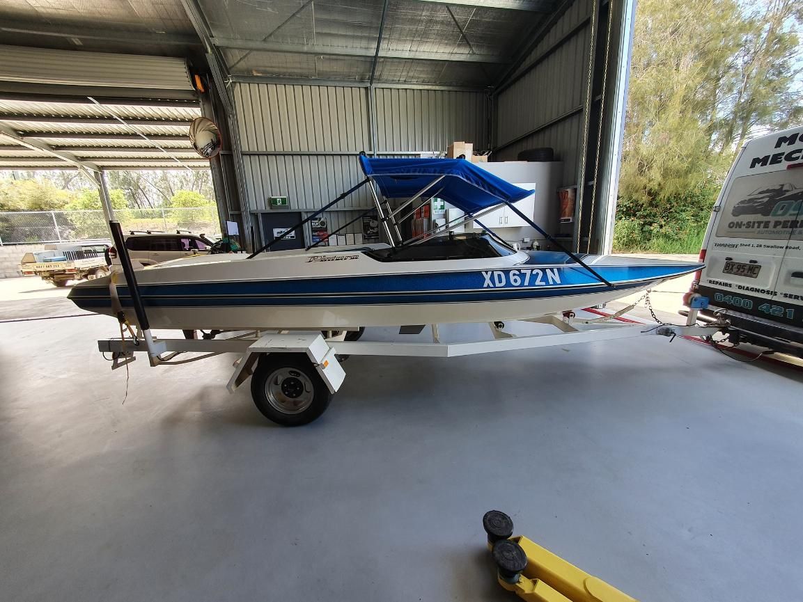 A Blue and White Boat is Parked in a Garage — OSP Automotive & Marine In Yamba, NSW