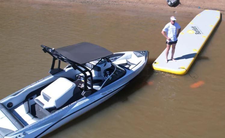 A Man is Standing Next to a Boat in the Water — OSP Automotive & Marine In Inverell, NSW
