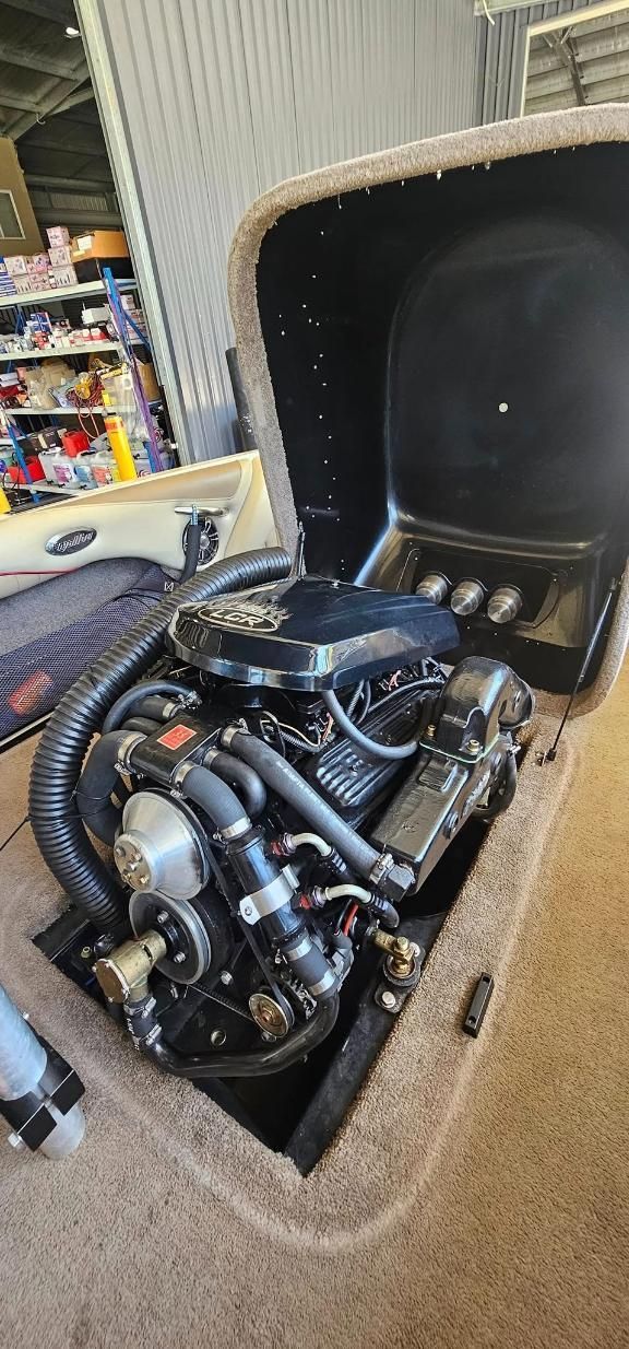 A Close Up of a Boat Engine in the Back of a Boat — OSP Automotive & Marine In Woolgoola, NSW
