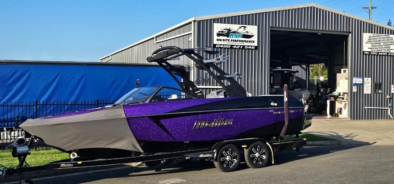 A Purple and Black Boat is Parked in Front of a Building — OSP Automotive & Marine In Grafton, NSW