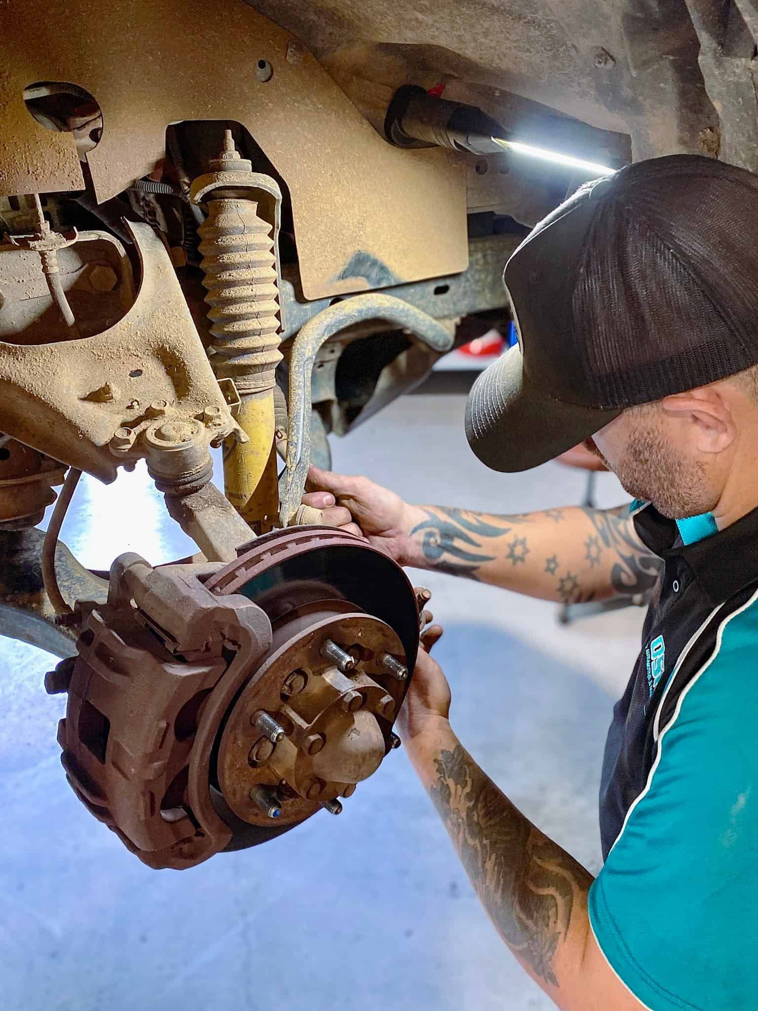 A Man is Working on a Car in a Garage — OSP Automotive & Marine In Grafton, NSW
