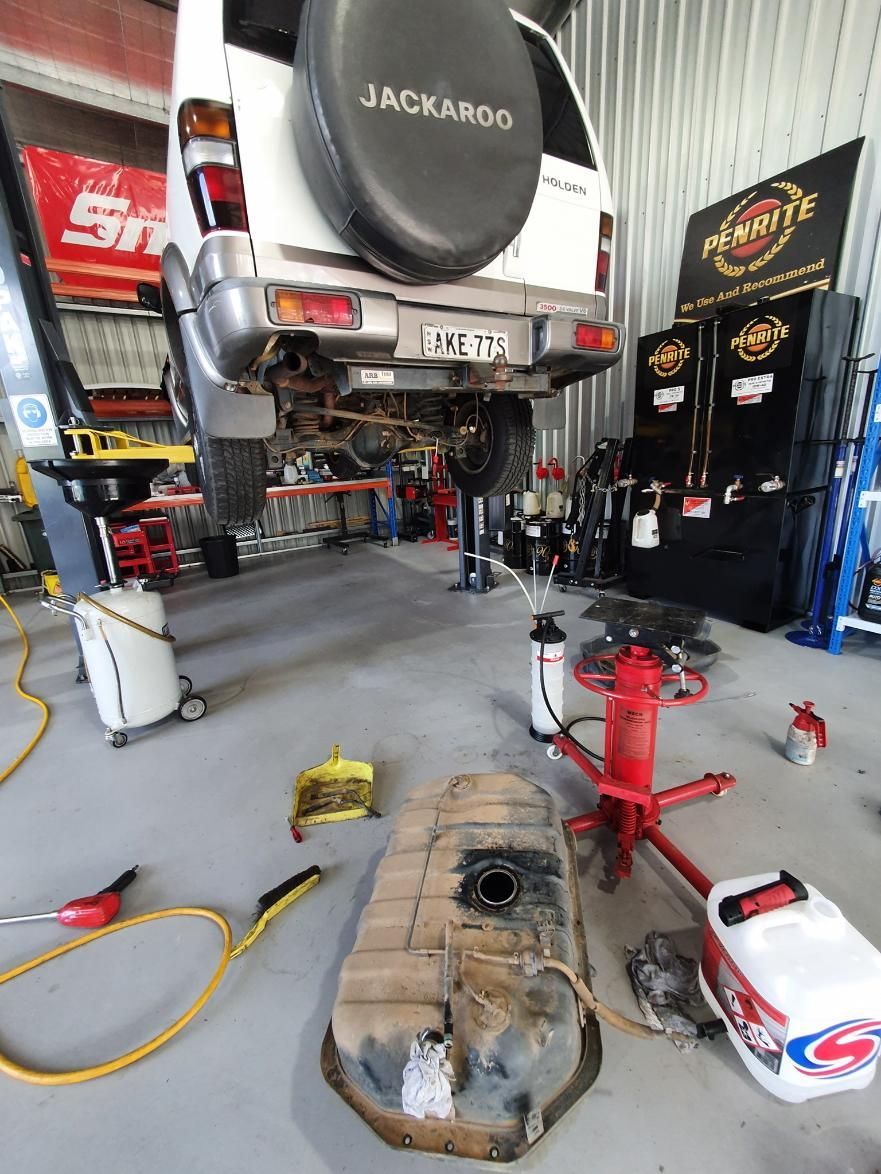 A White Suv is Being Worked on in a Garage — OSP Automotive & Marine In Grafton, NSW