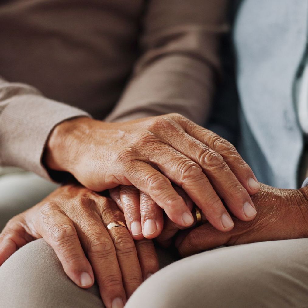 A close up of a person holding another person 's hand