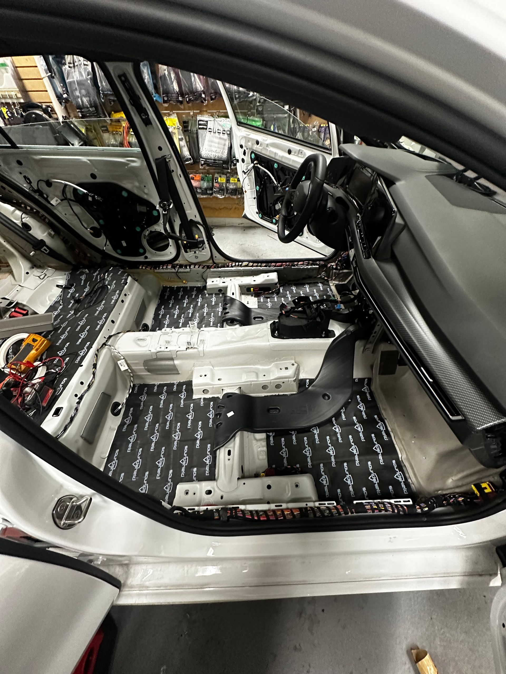 The back seat of a car with a box underneath it