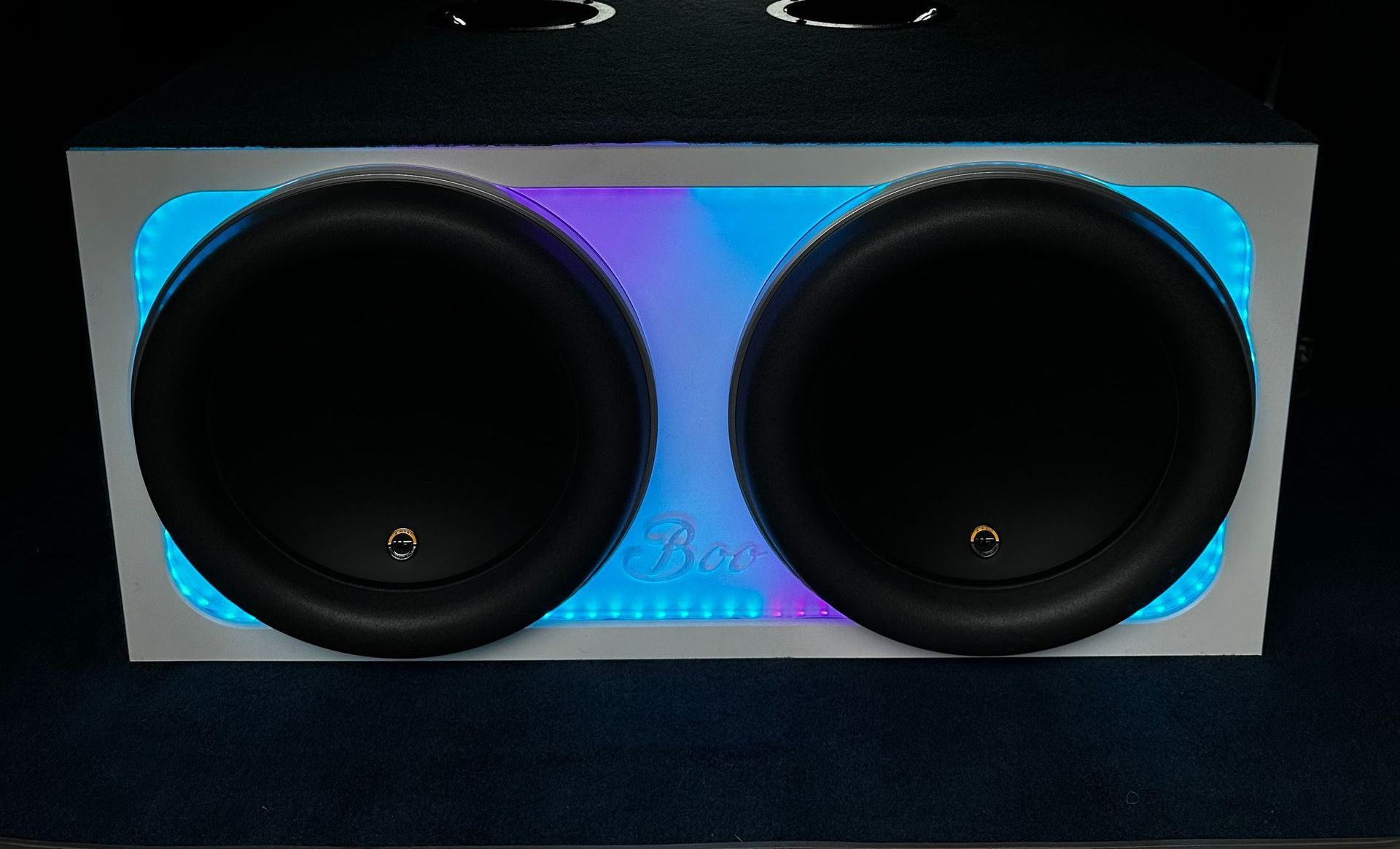 The interior of a slingshot is lit up with purple lights