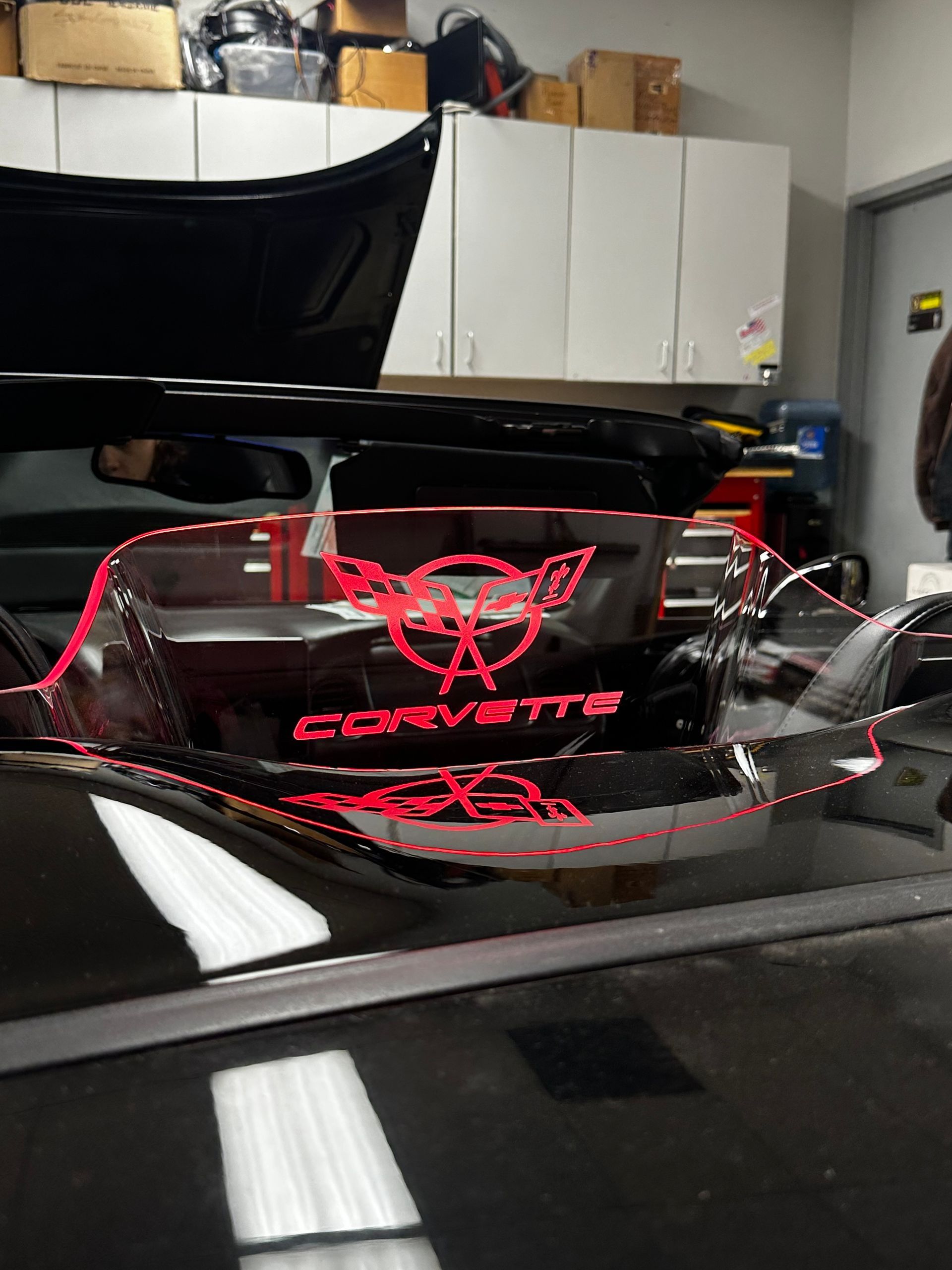 A blue light is shining on a speaker in the back of a vehicle