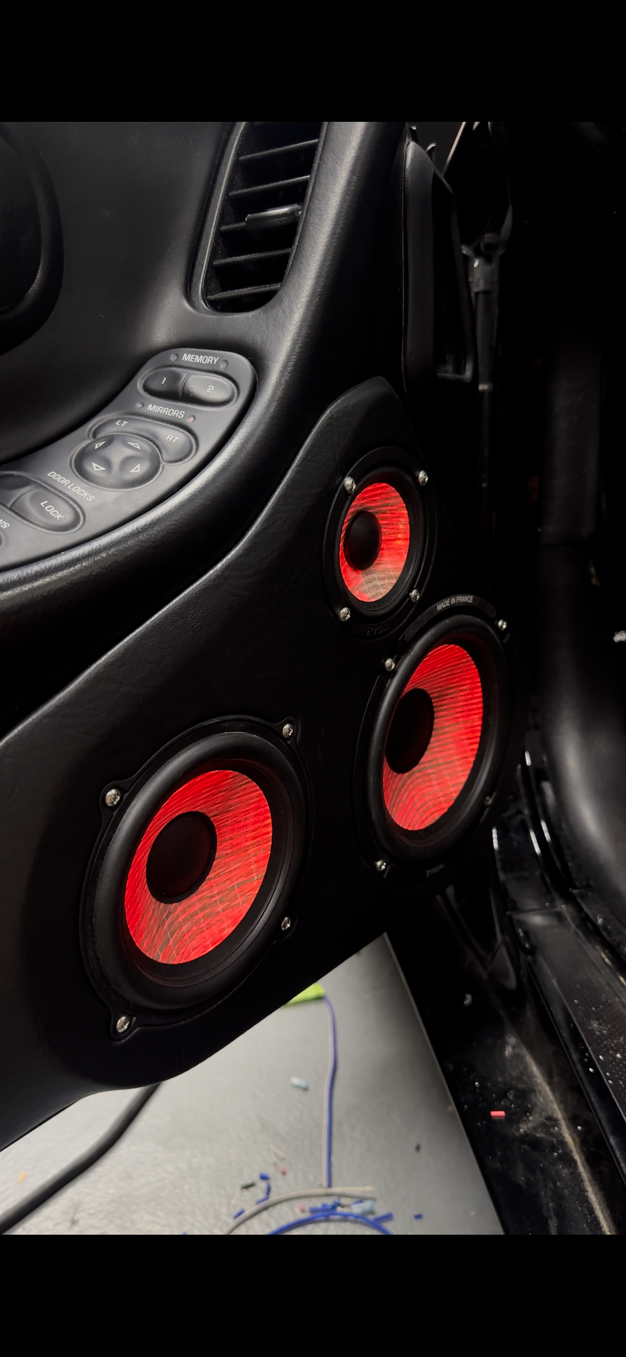 A black audi car is parked in a garage