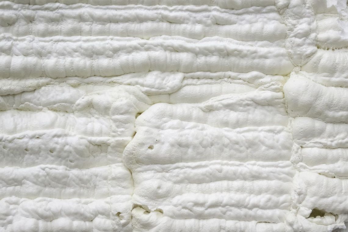 A close up of a piece of white foam on a wall.
