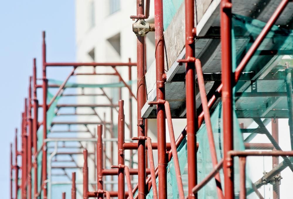 A Row of Red Scaffolding on A Building Under Construction — Lennox Head Scaffolding in Kinvara, NSW