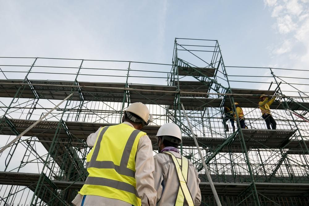 A Couple of Construction Looking at A Scaffolding — Lennox Head Scaffolding in Kinvara, NSW