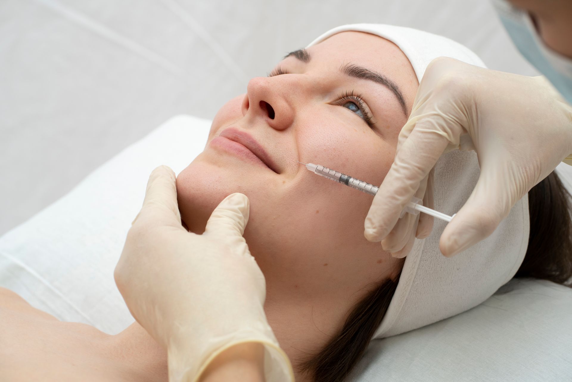 a woman is getting a botox injection in her face
