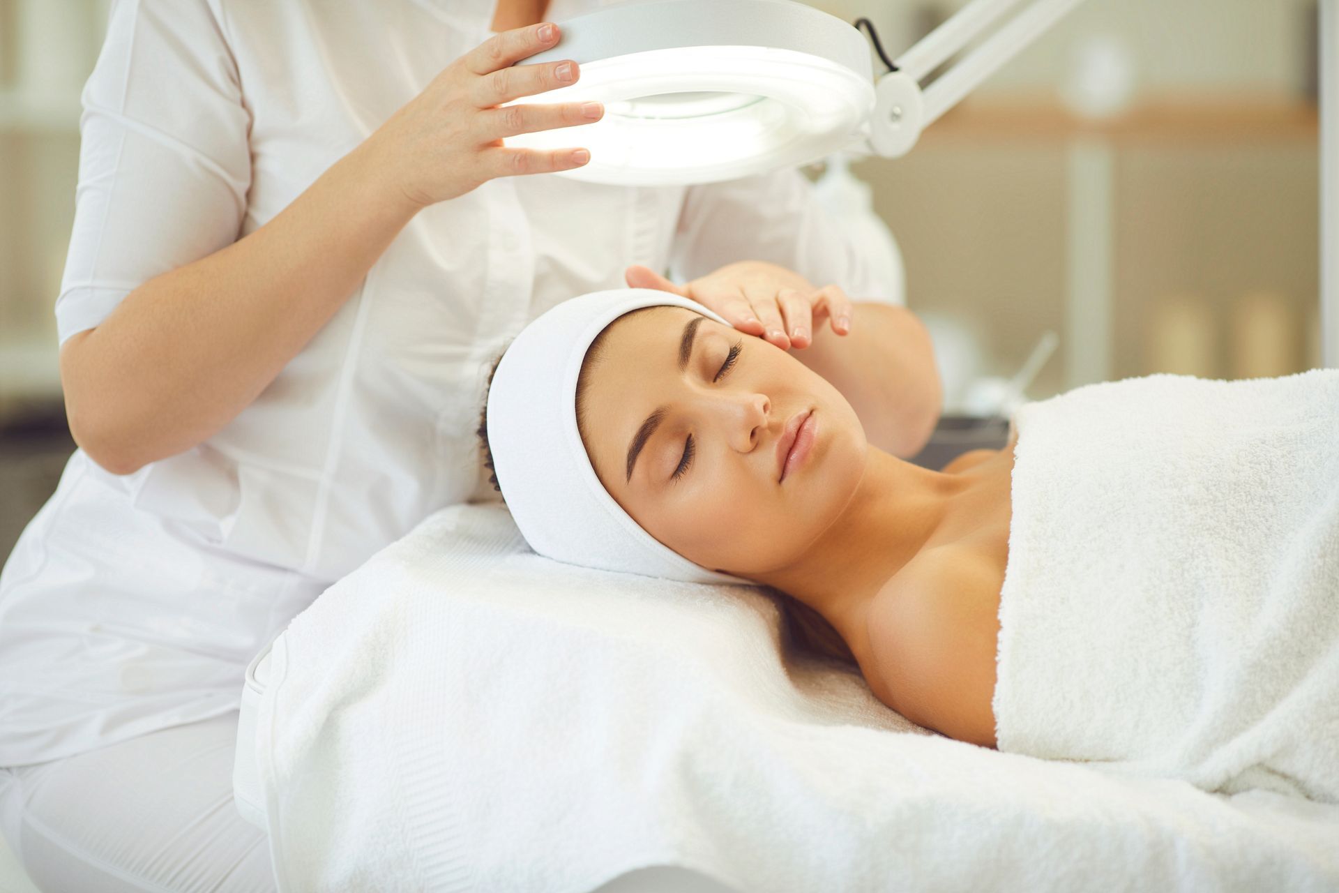 A woman is getting a facial treatment at a spa.