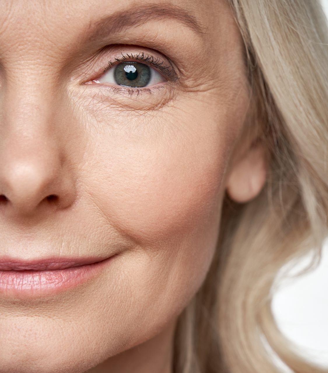 A close up of a woman 's face with a smile on her face.