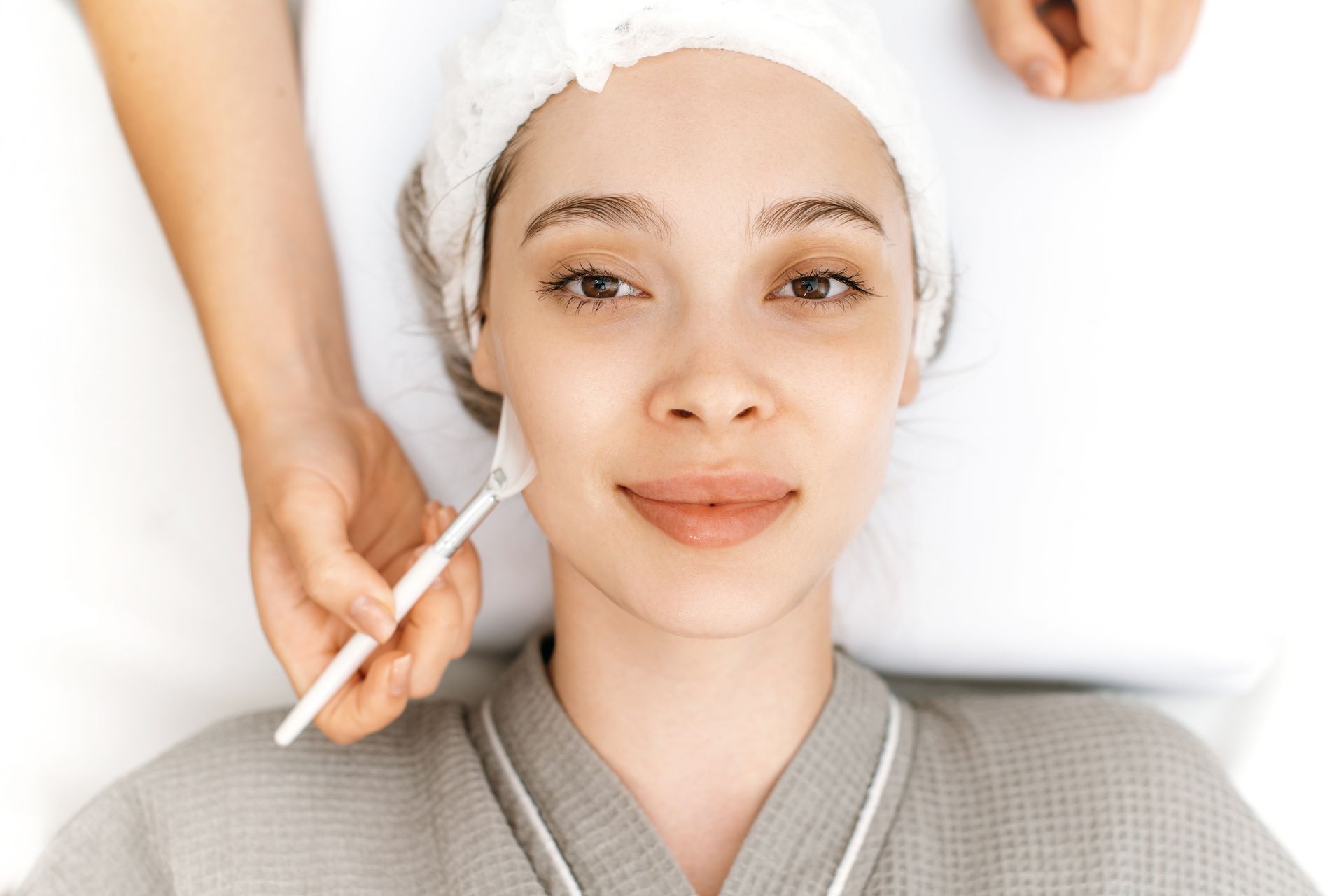 A woman is getting a facial treatment at a spa.